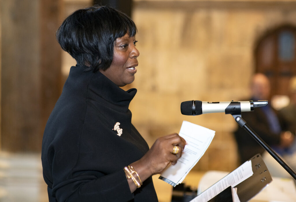 Heather Melville speaking at a lectern